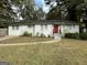 Newly renovated white brick ranch with red door and landscaping at 3168 Mcafee Rd, Decatur, GA 30032