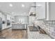 Modern kitchen with gas cooktop, granite countertops, and white cabinets at 92 Gordon Oaks Way, Moreland, GA 30259