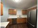Kitchen features wood cabinets, white countertops, and stainless steel appliances at 208 Rankin Cir, Mcdonough, GA 30253
