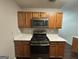 Kitchen with wood cabinets, gas range, microwave, and white countertops at 208 Rankin Cir, Mcdonough, GA 30253
