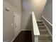 Staircase and entry door with dark hardwood floors at 208 Rankin Cir, Mcdonough, GA 30253