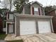 Brick two-story house with a two-car garage and red shutters at 208 Rankin Cir, Mcdonough, GA 30253