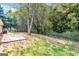 Spacious backyard with a patio, surrounded by trees and a privacy fence at 138 Michelle Dr, Mcdonough, GA 30252