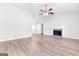 Spacious living room featuring hardwood floors, a fireplace, and a ceiling fan at 138 Michelle Dr, Mcdonough, GA 30252