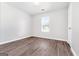 Bright bedroom with wood-look flooring and large window at 138 Michelle Dr, Mcdonough, GA 30252