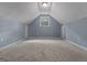 Bonus room features a sloped ceiling, carpet, and built-in storage at 335 Gum Creek Rd, Roopville, GA 30170