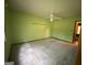 Bedroom with light green walls, ceiling fan, and carpeting at 416 Winterwood Dr, Stockbridge, GA 30281