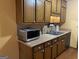Kitchen with wood cabinets, double sink, and microwave at 416 Winterwood Dr, Stockbridge, GA 30281