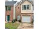 Brick townhouse with a one-car garage at 150 Brookview Dr, Riverdale, GA 30274