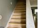 Staircase with light wood risers and gold colored metal accents at 150 Brookview Dr, Riverdale, GA 30274
