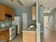 Kitchen with wood cabinets, white appliances, and a breakfast bar at 150 Brookview Dr, Riverdale, GA 30274