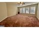 Well-lit bedroom featuring neutral walls and carpeting at 608 Cliff Lake Trl, Stockbridge, GA 30281