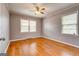 Spacious bedroom with hardwood floors and two windows at 241 Burke Cir, Mcdonough, GA 30253