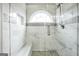 Bright shower with marble tile, pebble floor and glass enclosure at 1120 Strath Clyde Way, Mcdonough, GA 30253