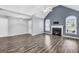 Open concept living area with hardwood floors and a fireplace at 1120 Strath Clyde Way, Mcdonough, GA 30253