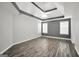 Main bedroom with hardwood floors, tray ceiling and neutral paint at 1120 Strath Clyde Way, Mcdonough, GA 30253