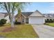 House exterior with stone accents and a two-car garage at 1120 Strath Clyde Way, Mcdonough, GA 30253