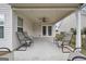Covered patio with ceiling fan and seating area, perfect for relaxing outdoors at 1120 Strath Clyde Way, Mcdonough, GA 30253