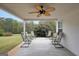 Relaxing patio with ceiling fan and seating for multiple people at 1120 Strath Clyde Way, Mcdonough, GA 30253