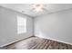 Simple bedroom with wood-look floors and ceiling fan at 1120 Strath Clyde Way, Mcdonough, GA 30253