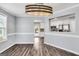 Dining room with hardwood floors and view into the kitchen at 1120 Strath Clyde Way, Mcdonough, GA 30253
