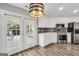 Kitchen with white cabinets, stainless steel appliances and access to a patio at 1120 Strath Clyde Way, Mcdonough, GA 30253