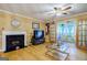 Living room with hardwood floors, fireplace, and access to a sunroom at 312 Brittany Ct, Duluth, GA 30096