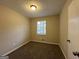 Cozy bedroom with carpet flooring and neutral wall colors at 6410 Buckhurst Trl, Atlanta, GA 30349