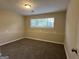Spacious bedroom with carpet flooring and large window at 6410 Buckhurst Trl, Atlanta, GA 30349