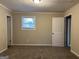 Bright bedroom featuring carpet, neutral walls, and a window at 6410 Buckhurst Trl, Atlanta, GA 30349