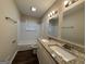 Updated bathroom with double vanity and granite countertops at 6410 Buckhurst Trl, Atlanta, GA 30349