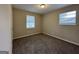 Well-lit bedroom with carpet flooring and neutral wall colors at 6410 Buckhurst Trl, Atlanta, GA 30349