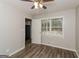 Spacious bedroom with wood-look floors, ceiling fan, and access to kitchen at 1262 Lorenzo Sw Dr, Atlanta, GA 30310