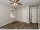 Bright bedroom with wood-look floors, ceiling fan, and ample closet space at 1262 Lorenzo Sw Dr, Atlanta, GA 30310