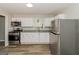 Modern kitchen with white cabinets, granite countertops, and stainless steel appliances at 1262 Lorenzo Sw Dr, Atlanta, GA 30310