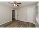 Bedroom with wood-look floors, ceiling fan, and access to closets and other rooms at 1262 Lorenzo Sw Dr, Atlanta, GA 30310