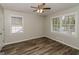 Well-lit bedroom featuring wood-look floors, ceiling fan, and large windows at 1262 Lorenzo Sw Dr, Atlanta, GA 30310