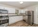 Modern kitchen with white cabinets, granite countertops, and stainless steel appliances at 1262 Lorenzo Sw Dr, Atlanta, GA 30310