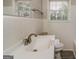 Clean bathroom with a white sink, vanity, and tiled walls at 1262 Lorenzo Sw Dr, Atlanta, GA 30310