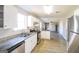 Modern kitchen features granite countertops, stainless steel appliances, and white cabinetry at 2124 Hairston Creek Pkwy, Decatur, GA 30035