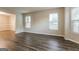 Spacious living room with hardwood floors and large windows at 7546 Petal Pl, Fairburn, GA 30213