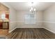 Bright dining room features hardwood floors and a view into the kitchen at 7546 Petal Pl, Fairburn, GA 30213