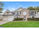 Two story house with two car garage and manicured lawn at 7546 Petal Pl, Fairburn, GA 30213