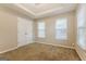Bright bedroom featuring two windows and a double door closet at 7546 Petal Pl, Fairburn, GA 30213