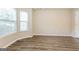 Simple bedroom with hardwood floors and large windows at 7546 Petal Pl, Fairburn, GA 30213