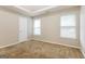 Simple bedroom with closet and two windows at 7546 Petal Pl, Fairburn, GA 30213