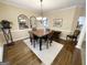 Spacious dining area with hardwood floors and a charming table setting at 1307 Eddie Craig Ct, Mcdonough, GA 30252