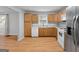 Kitchen with light wood cabinets, stainless steel appliances, and laminate flooring at 465 Haynie Rd, Moreland, GA 30259