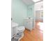 Simple bathroom with toilet, vanity, and wood flooring at 465 Haynie Rd, Moreland, GA 30259