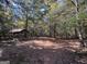 Wooded area with a clearing and covered structure at 1500 Pine Forest Rd, Mansfield, GA 30055